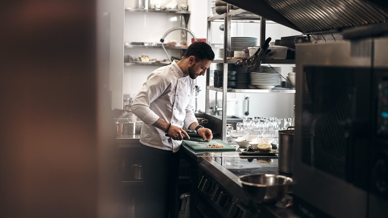 man in white dress shirt holding white ceramic plate