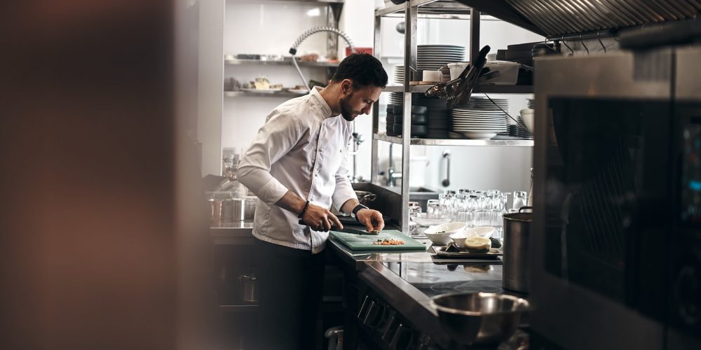 man in white dress shirt holding white ceramic plate